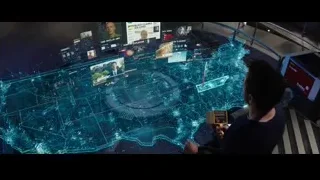 man looking at futuristic world map screen — Iron Man 3