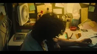 person at cluttered desk with head in hands — The Bear