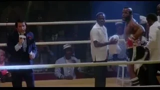 Man speaking to crowd in boxing ring — Rocky III