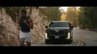man running on road by black Cadillac — Creed 3
