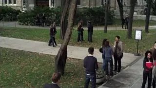 people walking and conversing on sidewalk — Suits