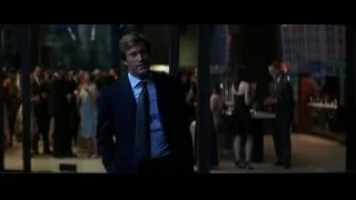 Man in suit walking through crowded room — Batman: The Dark Knight