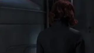 Woman standing in a dark room — The Avengers