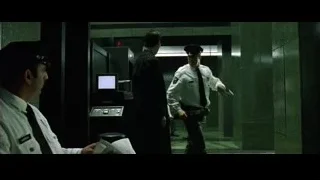 Officer explaining to man by control panel — The Matrix