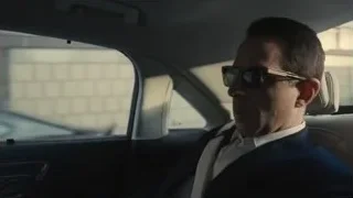Man in suit and sunglasses in car — Succession