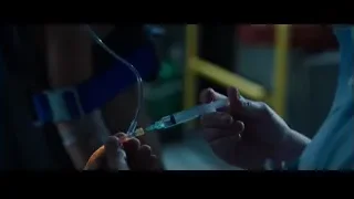 Man and woman in dimly lit workshop — Iron Man 3