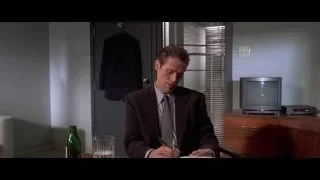 man writing at desk in office — American Psycho