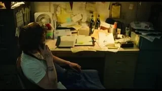 person sitting at desk talking on phone — The Bear