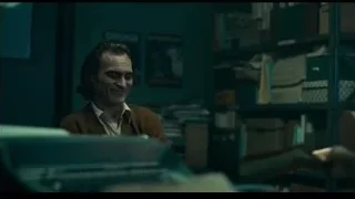 man sitting at desk in office — Joker