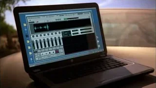 Laptop displaying music software on table — Breaking Bad