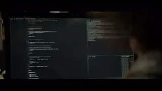person typing code on computer monitor — The Social Dilemma