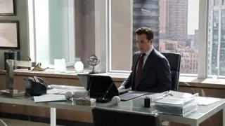 man in suit at office desk — Suits