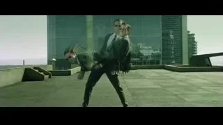 man in suit walking on rooftop — The Matrix