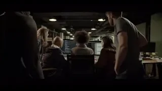 group working at computer monitors in control room — The Social Dilemma