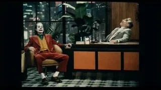 two men at desk with joker paint — Joker