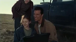 family looking at laptop by pickup truck — Interstellar