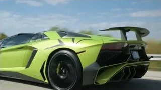 green sports car driving on highway with wind turbines — Sports Cars