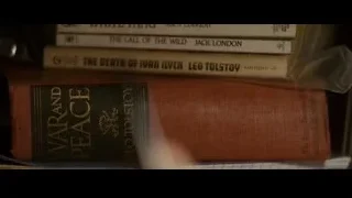 stack of books on a wooden shelf — Into the Wild