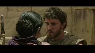 Man and woman embracing by a stone wall — Gladiator 2