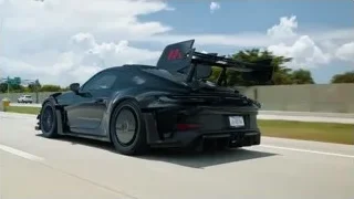 Black sports car driving on highway — Sports Cars