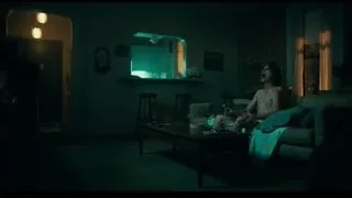 Man deep in thought in dim living room — Joker