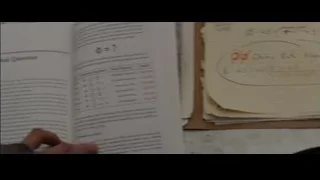 Desk with open notebook and handwritten equations — The Amazing Spider Man