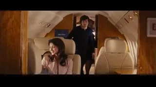 man and woman standing in airplane aisle — Now You See Me