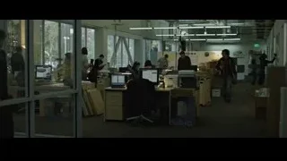 People working in office with glass walls — The Social Network