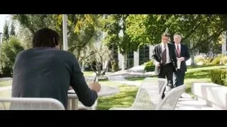 man walking towards woman writing in garden — Jobs