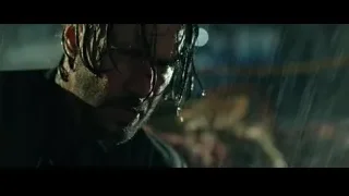 man's distressed face in rain at night — John Wick