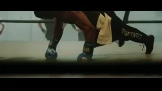 Man performing push-up in boxing ring — Creed 3