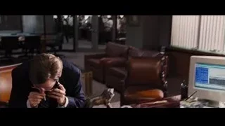 man at office desk with lion statue — The Wolf Of Wall Street