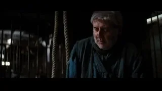 Man hanging from rope in dark room — Batman: The Dark Knight Rises