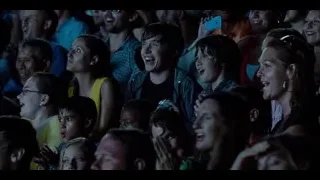 Crowd cheering with hands raised at concert — Jurassic World