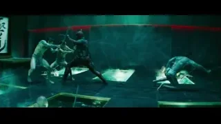 man fighting with a sword in a red brick room — Deadpool 2