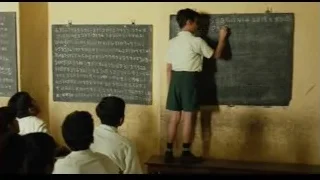 young boy writing on blackboard in old classroom — Life of Pi