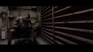 Man sitting on chair in dimly lit room — Creed