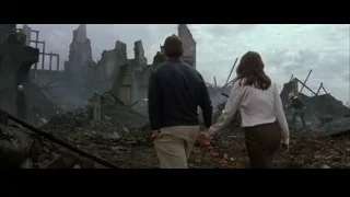 man and woman walking through building ruins — Batman