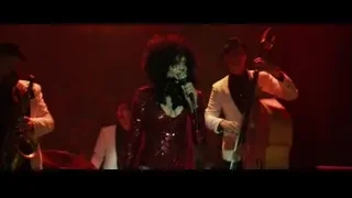 Musicians performing on stage with red lights — John Wick