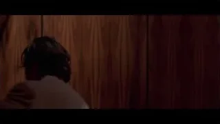 man deep in thought at desk in corridor — American Psycho