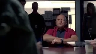 Bald man sitting at desk with arms crossed — Breaking Bad