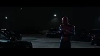 Spider-Man holding gun in parking lot at night — The Amazing Spider Man