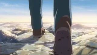 Feet standing on rocky cliff overlooking mountains — Your Name