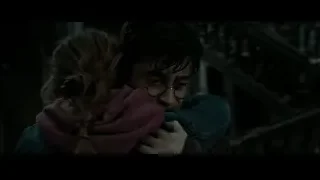 young man and woman hugging by staircase — Harry Potter and the Deathly Hallows 2