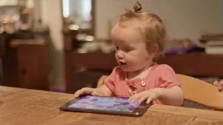 young girl playing with tablet at table — Screened Out