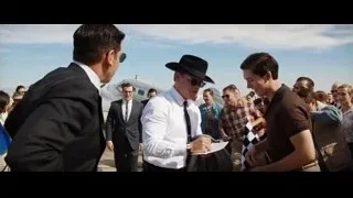Men in suits with cowboy hat in crowd — Ford v Ferrari
