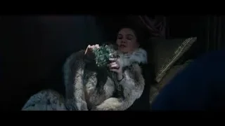 Woman in fur coat on couch with eyes closed — Gladiator