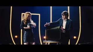 Man and woman on stage with microphone — Now You See Me