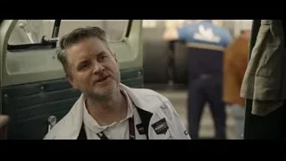 man speaking into microphone in green van — F1