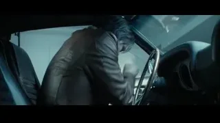 man sitting in car driver's seat — John Wick